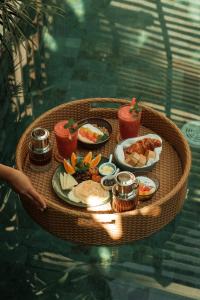 a table with a tray of food on it at Manao Villas - Luxury Boutique Resort in General Luna