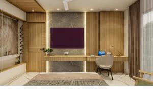 a bedroom with a bed and a desk and a television at Hotel Vaarya Inn in Lucknow