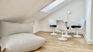 a living room with a couch and chairs and a table at STACEY Alster in Hamburg