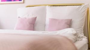 a bed with white sheets and pillows at STACEY Alster in Hamburg