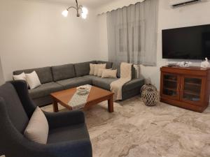 a living room with a couch and a table at Panora House in Kefalos