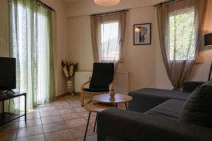 a living room with a couch and a table at Sunset Stories Apartments in Konitsa