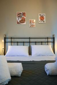 a bedroom with a bed with two pillows at Sunset Stories Apartments in Konitsa