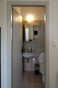 a small bathroom with a sink and a toilet at Sunset Stories Apartments in Konitsa +19 photos