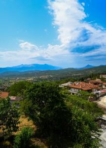 a view of a city with mountains in the distance at Sunset Stories Apartments in Konitsa