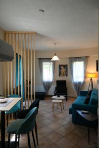 a living room with a blue couch and chairs at Sunset Stories Apartments in Konitsa
