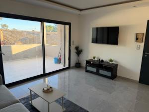 a living room with a couch and a flat screen tv at appartement Sorgues in Sorgues