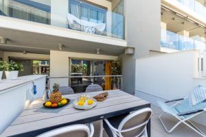 a balcony with a table with fruit on it at Luxurious Two Bed in Torrox