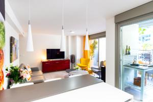 a living room with a table and chairs and a television at Luxurious Two Bed in Torrox