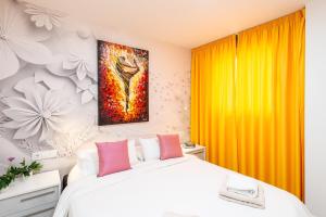 a bedroom with a bed and a painting on the wall at Luxurious Two Bed in Torrox +29 photos