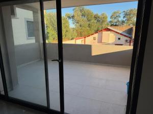 an open glass door with a view of a balcony at appartement Sorgues in Sorgues