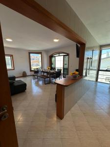 a living room with a table and a couch at RAFURADOURO in Ovar