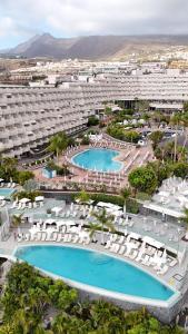 an aerial view of a resort with two swimming pools at Landmar Playa La Arena in Puerto de Santiago