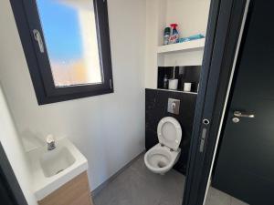 a small bathroom with a toilet and a sink at appartement Sorgues in Sorgues +7 photos