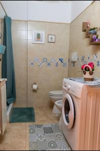 a bathroom with a washing machine and a toilet at Heidi Montelivata in Subiaco