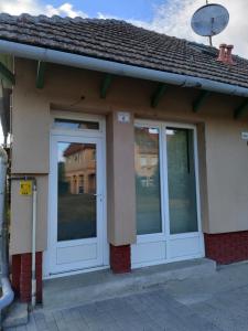 two doors on the side of a building at LŰN Apartman in Dunaföldvár