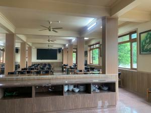 a large room with tables and chairs and a screen at Bavieco Resort in Yên Bài