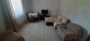 a living room with two couches and a tv at Гостевой дом in Sevan