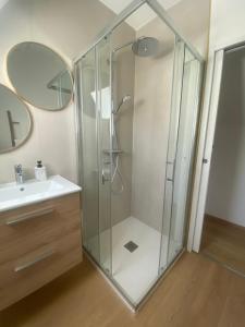 a glass shower in a bathroom with a sink at Four Bas in Martel