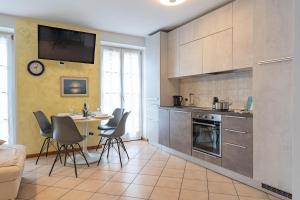 a kitchen with a table and chairs in a room at Casa Cataleya, Tuenno Ospitar in Tuenno +24 photos