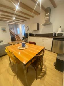a kitchen and dining room with a wooden table and chairs at Four Bas in Martel