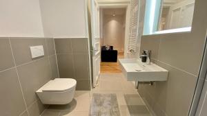 a bathroom with a toilet and a sink at STACEY Downtown in Hamburg