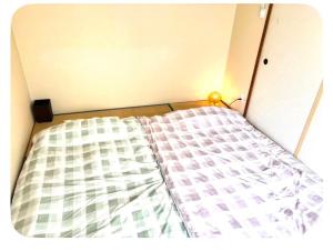 a bed in a box with a mattress at パールビル201 in Osaka