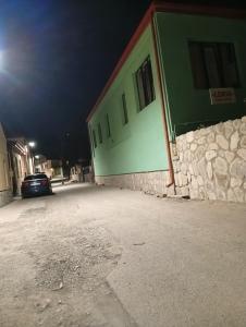 a car parked in front of a building at night at LZ Green House in Telavi