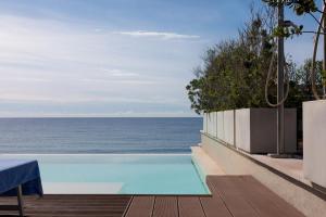 a swimming pool with a view of the ocean at Affittacamere Mare Poetto Cagliari in Quartu Sant'Elena