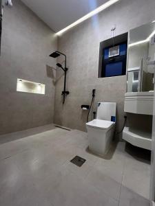 a bathroom with a toilet and a sink at هابينيس شاليه in Salalah +23 photos