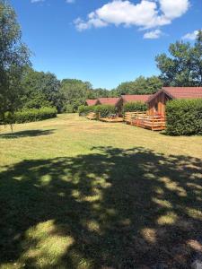 a large yard with a large shadow of a tree at Chalet de luxe in Uxelles