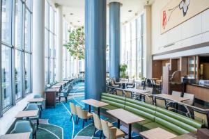 a cafeteria with tables and chairs and large windows at Shibuya Excel Hotel Tokyu in Tokyo