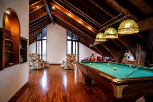a living room with a pool table and chairs at VivimiHome - Rifugio Genzianella in San Domenico