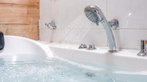 a bath tub with water pouring from a faucet at Youngheungdo Roma Spa Pension in Incheon +10 photos