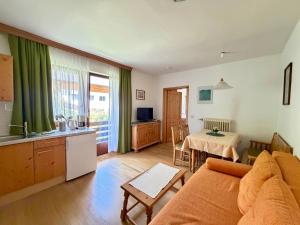 a living room with a couch and a table at Appartements Lärchenhof in Bad Kleinkirchheim