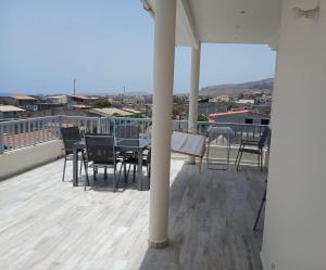 a patio with a table and chairs on a roof at Caetana e Ferro in Calheta