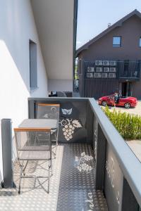 a table and a chair on a balcony at Vila Trta in Moravske-Toplice