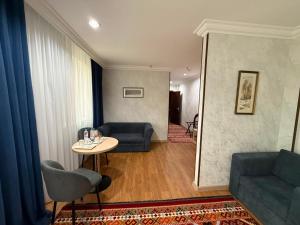 a living room with a couch and a table at King Hotel Astana in Astana