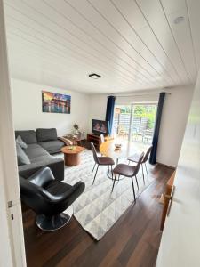 a living room with a couch and a table and chairs at Room in Rendsburg in Rendsburg