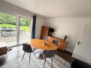 a dining room with a wooden table and chairs at Room in Rendsburg in Rendsburg
