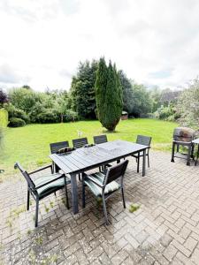 a picnic table and chairs on a brick patio at Room in Rendsburg in Rendsburg