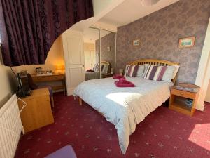 a bedroom with a large bed in a room at Adam Place Guest House in Windermere