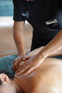 a woman getting a back massage from a therapist at Landmar Playa La Arena in Puerto de Santiago +82 photos