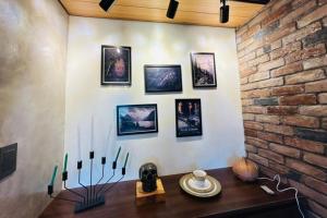 a dining room with a table and a brick wall at Crosswinds Nature View Suite in Tagaytay