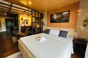 a bedroom with a large bed in a room at Crosswinds Nature View Suite in Tagaytay