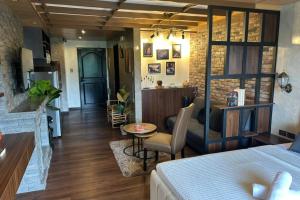 a bedroom with a bed and a living room at Crosswinds Nature View Suite in Tagaytay +120 photos