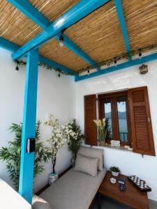 a porch with a bench under a wooden ceiling at Miloa Klima View 'Syrma' in Klima
