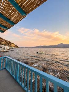 a boat on the water with a blue railing at Miloa Klima View 'Syrma' in Klima