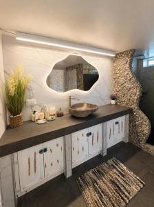 a bathroom with a sink and a mirror at Miloa Klima View 'Syrma' in Klima +55 photos