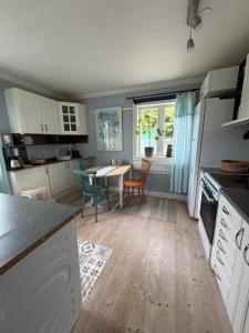 a kitchen with a table and a dining room at Charming, quiet apartment in Kvissleby